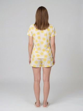 Women's sleepwear set with a lemon print, seen from the back.