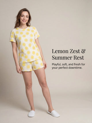 Women's light yellow crew neck t-shirt with a pattern of lemon slices, paired with matching shorts.