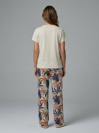 Women's light beige t-shirt and floral print pajama pants.