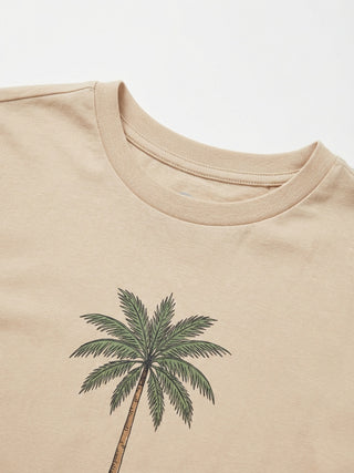 Women's beige crew neck t-shirt with a palm tree print.