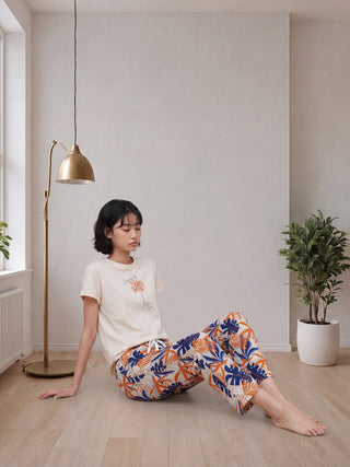 Women's light beige t-shirt and floral print pajama pants.
