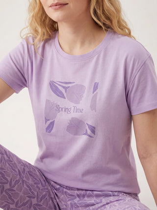 Women's light purple short-sleeve t-shirt with a "Spring Time" tulip graphic and matching floral patterned pants.