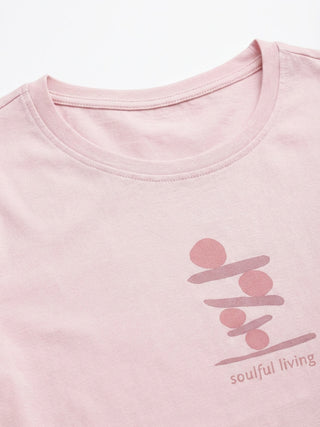 Women's light pink t-shirt with a stacked circular and line design and "soulful living" text.