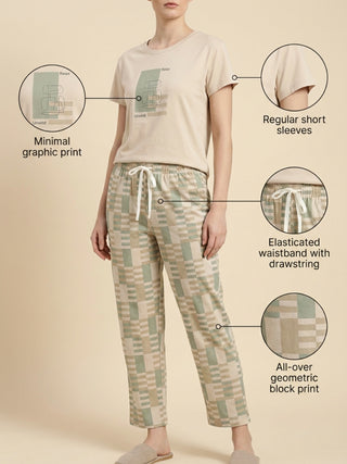 Women's cream relaxed-fit t-shirt with a minimal graphic print and matching green and beige geometric block print pajama pants with an elasticated waistband and drawstring.