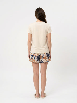 Women's light beige short-sleeve t-shirt and floral print shorts.