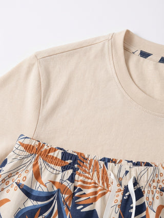 Women's beige t-shirt and floral print shorts.