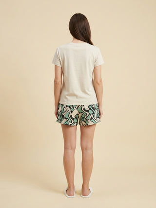 Women's beige t-shirt and abstract printed shorts.