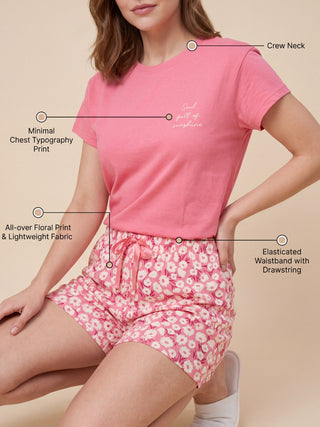 A woman in pink floral sleep shorts and a pink t-shirt with "Soul full of sunshine" printed on it.
