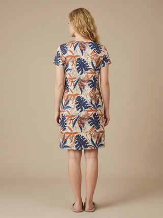 Women's short-sleeve knee-length dress in beige with a tropical leaf print of blue and rust.