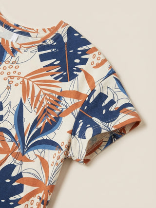 Women's cream short-sleeve t-shirt with a tropical leaf print in blue and burnt orange, featuring a slightly different print pattern and sleeve cut.