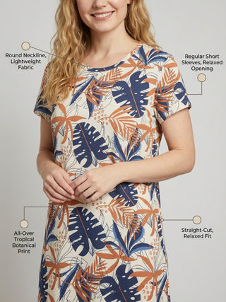 Women's cream short-sleeve midi dress with a navy and rust tropical botanical print, featuring a round neckline, relaxed fit, and side seam pockets.