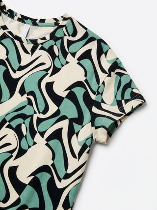 Women's t-shirt in beige with an abstract black and teal wavy print.