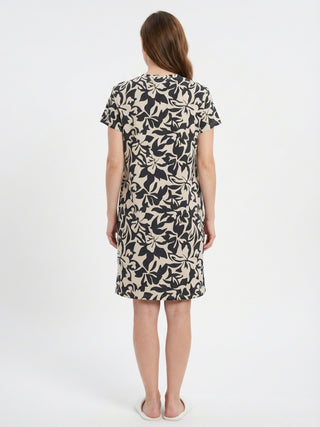 Women's short-sleeve, cream and black floral print t-shirt dress, shown from the back.
