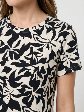 Women wearing a cream and black floral print short-sleeved t-shirt.