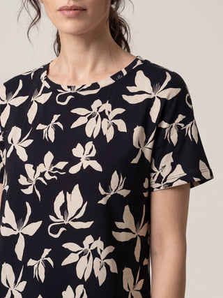 Women wearing a navy blue t-shirt with a floral print.