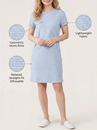 A woman in a light blue geometric print sleep dress with a relaxed fit.