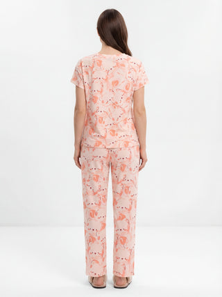 Women's light peach pajama set with a playful flamingo print, shown from the back.