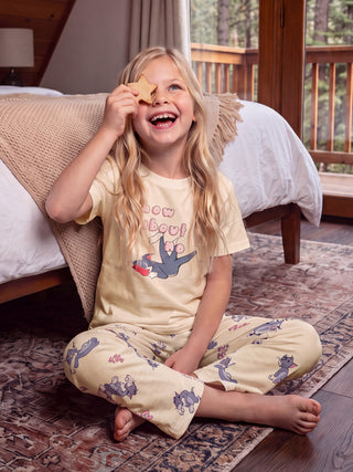 GIRLS light yellow pajamas with a "How About" print and Tom and Jerry characters.