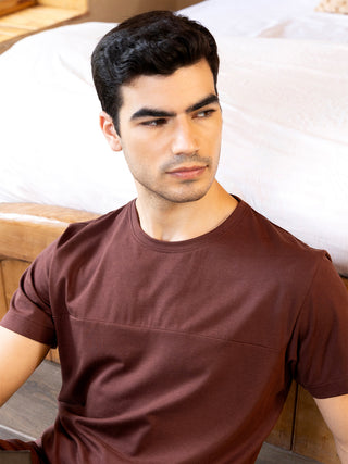 Men in a dark brown short-sleeved t-shirt with a horizontal seam detail.