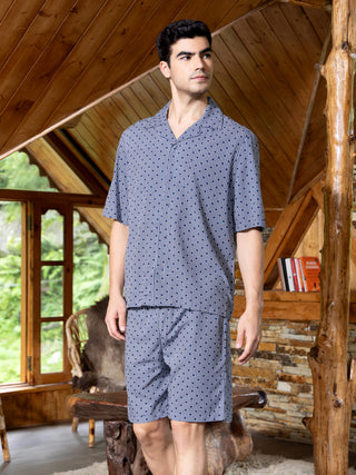 Men's navy blue geometric print pajama set, standing.