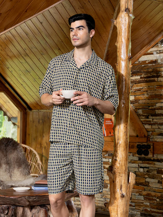 Men wearing a navy and yellow patterned pajama set.