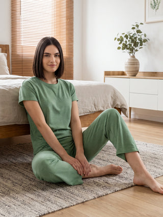 Woman wearing a green printed pajama set.