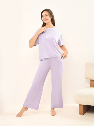 a women wearing a lilac snow simply lazy pyjama set made of modal spandex