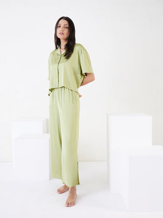 a women standing wearing blue breeze pyjama set made of satin fabric