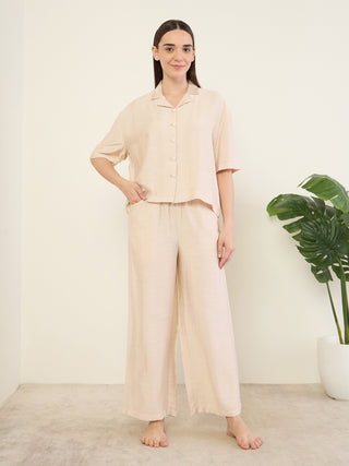 Women in a beige linen pajama set.