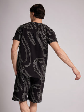 Men's black t-shirt and shorts set with a swirling white abstract print, seen from the back.