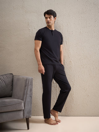 a men wearing a black gentlemen solid pyjama set made of cotton modal spandex