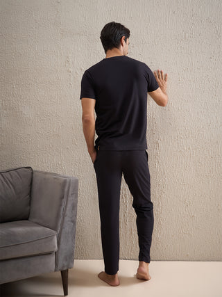 a men standing wearing black gentlemen solid pyjama set made of cotton modal spandex