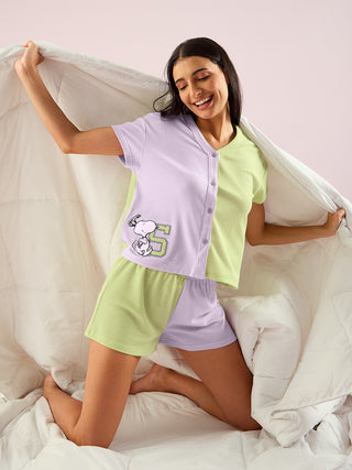 a women wearing green lily half sleeve front open shorts set