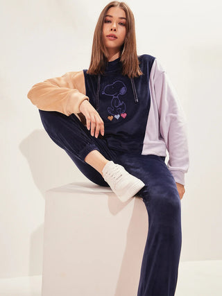 a girl sitting on chair wearing navy colour round neck track suit
