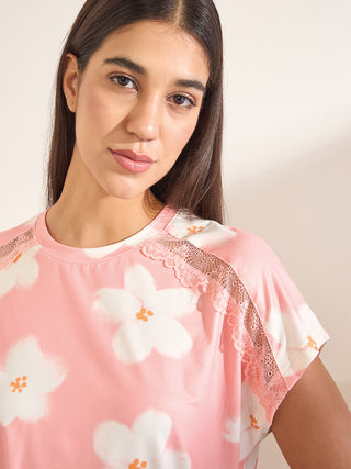 Women's pink floral print sleep shirt with lace trim.