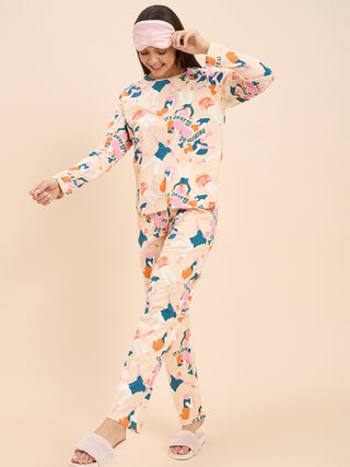 a woman standing against the wall peach long sleeve pyjama set