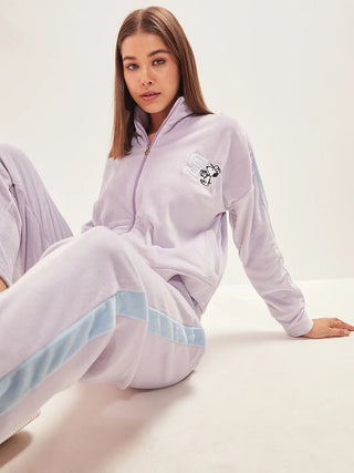 a girl sitting wearing purple heather color track suit