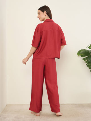 Women wearing a red two-piece pajama set with a collared short-sleeved top and wide-leg pants.