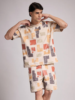 Men in a beige, geometric-print t-shirt and shorts set.
