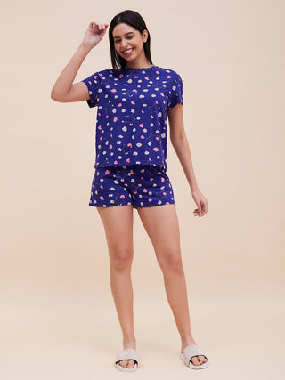 a woman happily standing wearing royal blue pyjama set