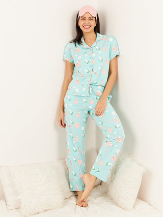 a woman smiling and standing wearing aqua splash half sleeve pyjama set