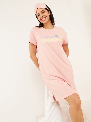 a woman standing and wearing pink half sleeve short dress 