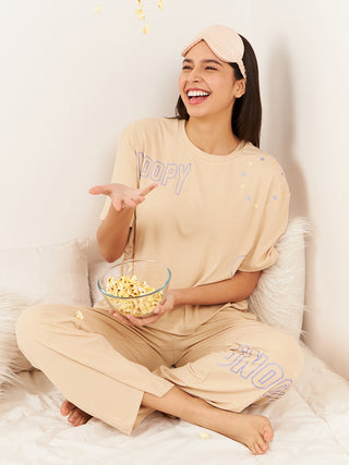 a women sitting with popcorn wearing sand snoopy starlet pyjama set made of comfy rib